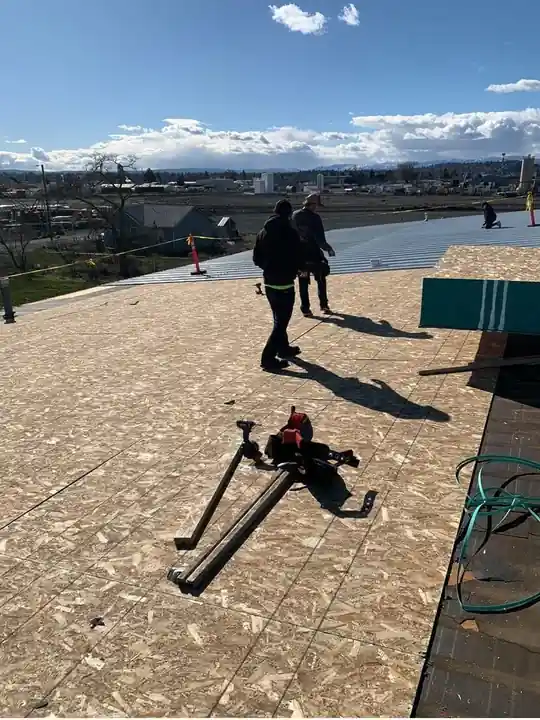 Yakima Roofing & Remodeling crew resheeting the Decco USA roof with 7/16 OSB