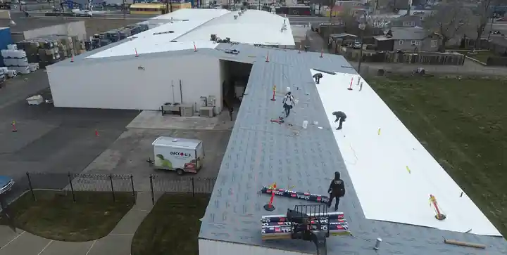 Aerial view of the Yakima Roofing crew rolling out TPO membrane at Decco USA in Yakima