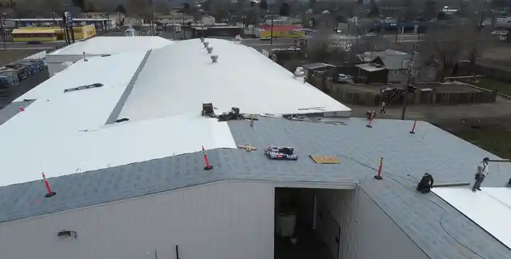 New white TPO membrane meeting the substrate as installation progresses at Decco USA