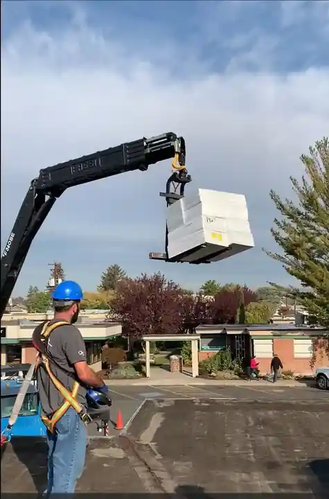 Pallet of 60 mil TPO being lifted onto the LabCorp roof in Yakima
