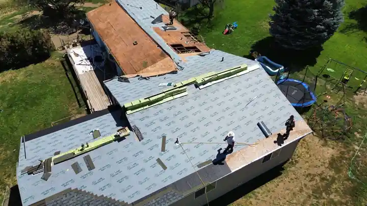 Aerial view of the manufactured home project in Yakima with roofing under way and truss repairs in progress