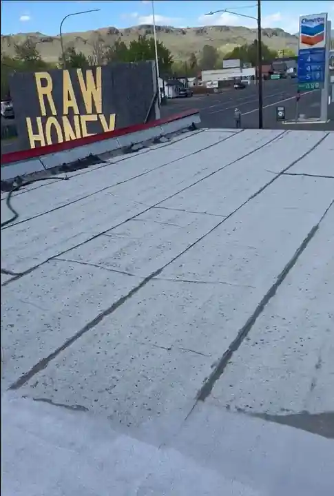 The worn-out four-layer roof on the Naches Fruit Stand before work began