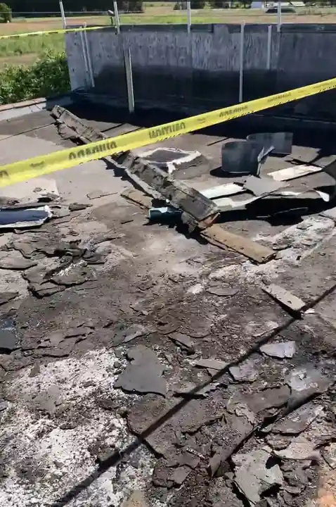 Crew peeling back the four layers of old roofing at the Naches Fruit Stand