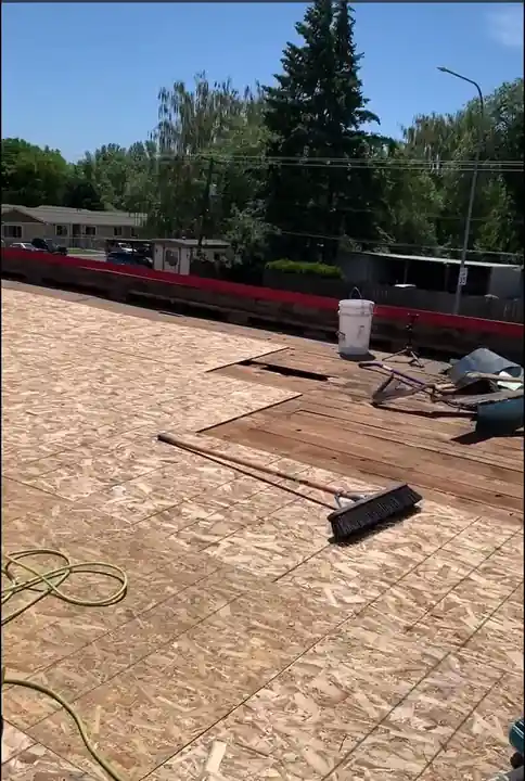 Tear-off in progress on the Naches Fruit Stand roof, old material stripped away