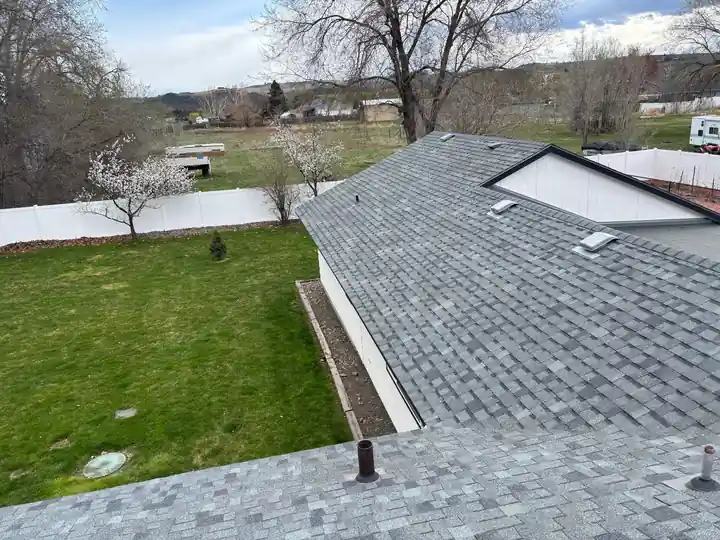 Second drone view of the grey architectural shingle roof and skylight