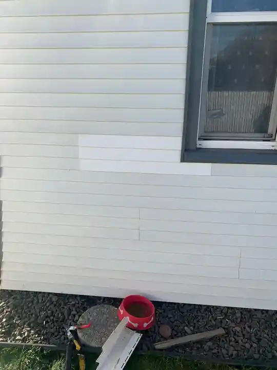 A replaced vinyl siding panel matched to the surrounding wall